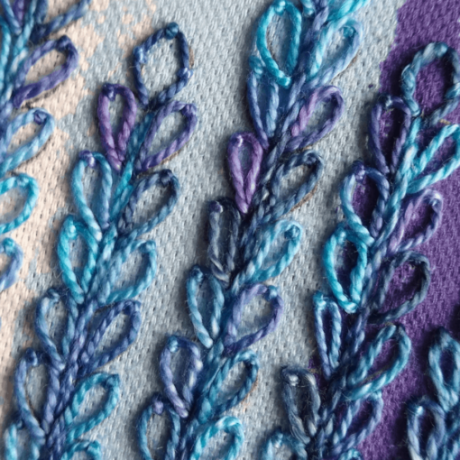 Close-up of delphinium embroidery kit in blue and purple