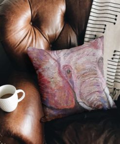 Elephant cushion on leather armchair
