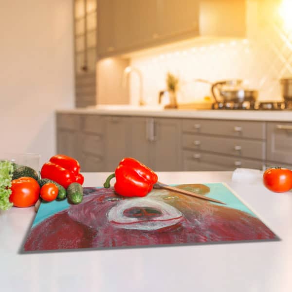 Red bear glass cutting board on kitchen counter
