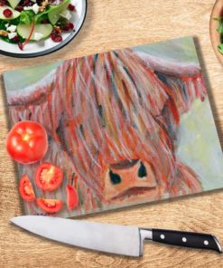 Highland Cow Glass Chopping Board on a table