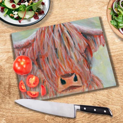 Highland Cow Glass Chopping Board on a table