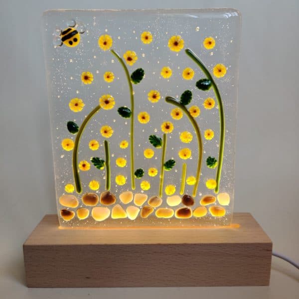 Clear fused glass panel with sunflowers and a bee in a wooden led block