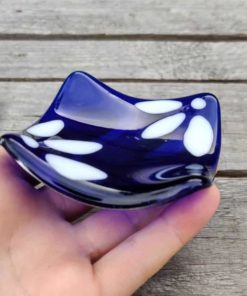 Blue and white trinket dish being held.