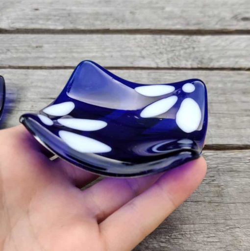 Blue and white trinket dish being held.