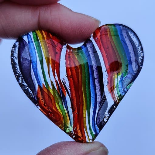 Rainbow coloured fused glass heart hug from Spinnaker Glass