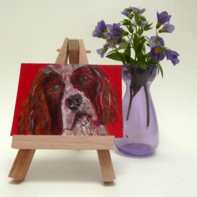 Miniature Springer Spaniel dog painting on wooden easel