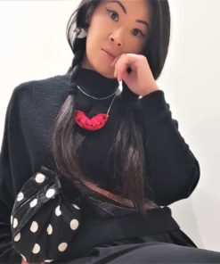 model wearing a spotty belt bag and red necklace