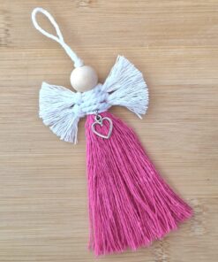 Handmade angel ornament with a wooden bead head, white yarn wings, and a pink yarn body featuring a silver heart charm.