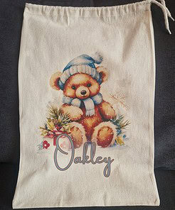 Personalised Christmas teddy bear bag with cute teddy bear in a blue hat, drawstring closure, perfect for Christmas gifts.