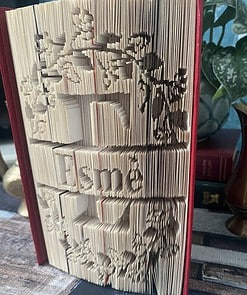 A book with intricately folded pages creating a 3D image and 