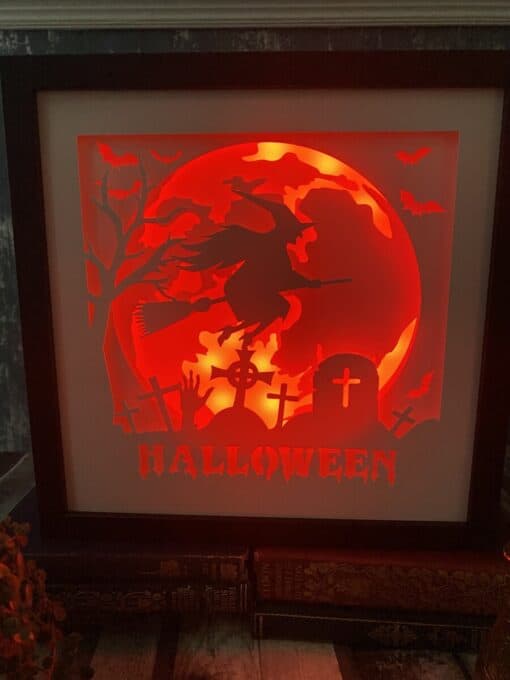 Glowing Halloween artwork features a witch on a broomstick, graveyard, bats, and a red moon with "Halloween" text.