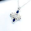 Silver star-shaped pendant with a central clear gem, accented by blue teardrop-shaped stones on a delicate silver chain.