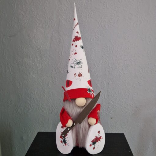 Halloween gnome with a long beard, red and white hat, holding a knife, decorated with spiders and fake blood splatters.