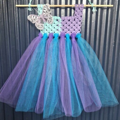 Handmade tutu dress with a crochet bodice in purple and mint, adorned with a butterfly, and blue and purple tulle skirt.