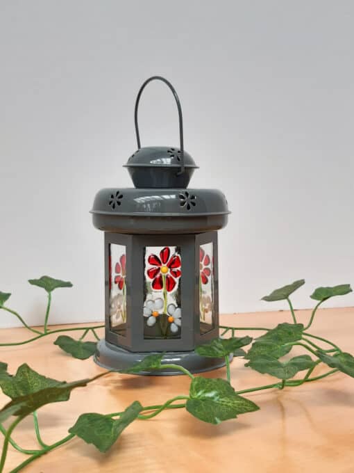 Grey lantern with red and white flowers