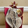 Heart book fold with red and gold cover, with paper flowers inside, and a paper butterfly on the front.