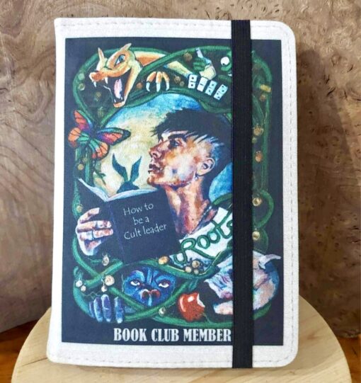 Illustrated book cover depicting a person reading "How to be a Cult Leader," surrounded by mystical creatures and plants.