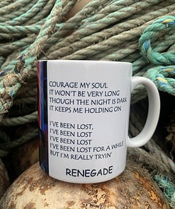 Mug with motivational song lyrics, surrounded by coiled ropes, evokes themes of perseverance and resilience.