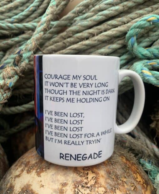 Mug with motivational song lyrics, surrounded by coiled ropes, evokes themes of perseverance and resilience.