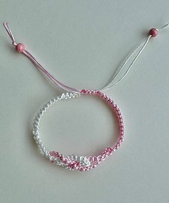 Macrame knotted bracelet - fully adjustable with a sliding knot. Made from 1mm pink and white braided nylon cord.