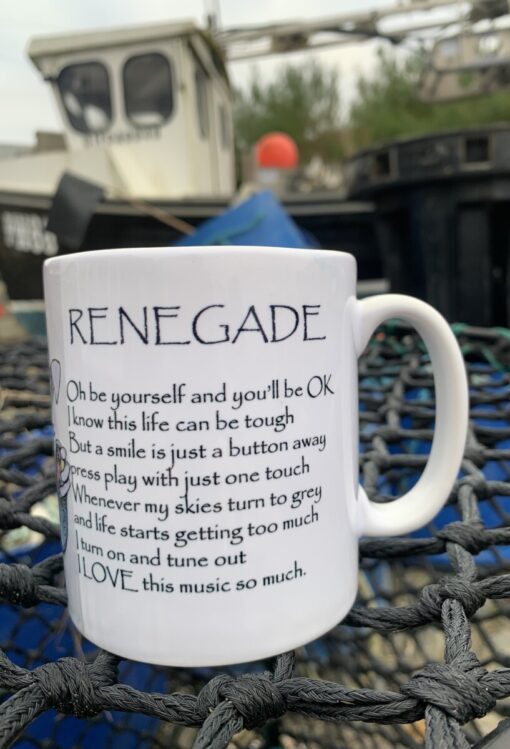 White mug with text "RENEGADE" and a motivational quote, on a net background with a blurred boat in the distance.