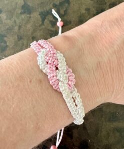 Macrame knotted bracelet - fully adjustable with a sliding knot. Made from 1mm pink and white braided nylon cord. Fits most adult wrists.