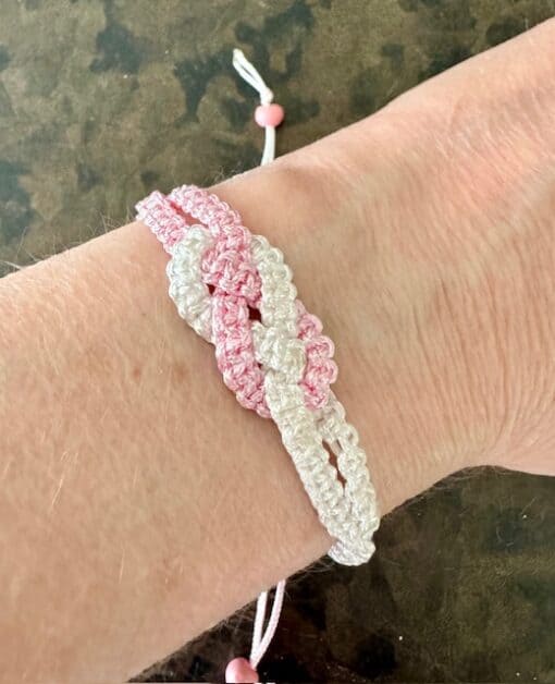 Macrame knotted bracelet - fully adjustable with a sliding knot. Made from 1mm pink and white braided nylon cord. Fits most adult wrists.