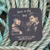 Illustrated coaster with two men, text reads "Down on the Beat" and "I don't lose sleep in the whispers of sheep," on rope background.