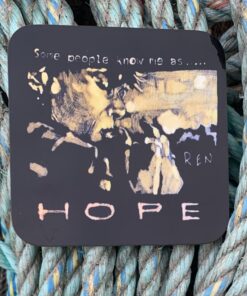 Artwork on black plaque reading "Some people know me as... HOPE" set against a background of woven ropes.