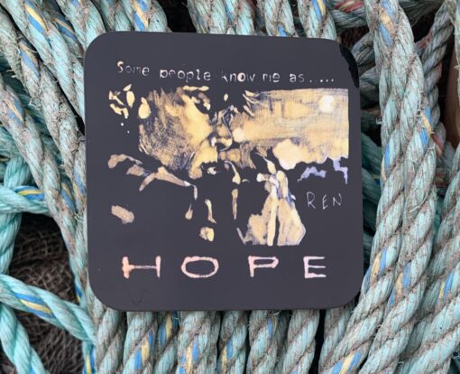 Artwork on black plaque reading "Some people know me as... HOPE" set against a background of woven ropes.