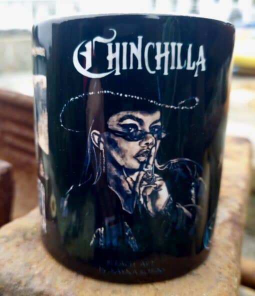 Black mug featuring a stylized illustration of a woman in sunglasses and hat, with "Chinchilla" text above.