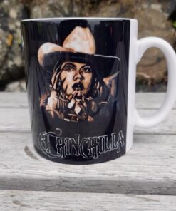 Black mug on wooden table featuring art of a cowboy with 