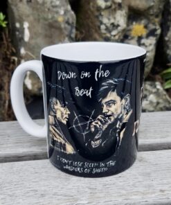 Black mug with artistic illustrations of men, featuring text 