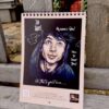 Ren Gill art calendar with Sock Boi design, showcasing a decorative illustration on a rustic bench.