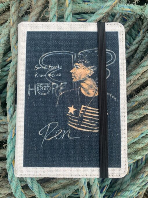 Notebook cover with illustration of a man, text "Some people know me as HOPE," and the name "Ren," against rope background.