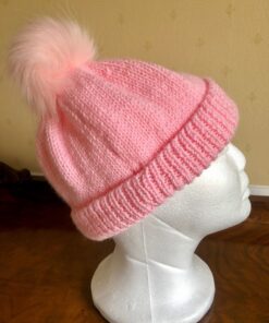 Hand knitted hat in a beautiful pink DK yarn, with a synthetic removable pom pom. Will fit most adults.