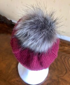 Hand knitted hat in a gorgeous plum colour. The synthetic pom pom can be detached for ease of washing. Sized as medium but will fit most adults.
