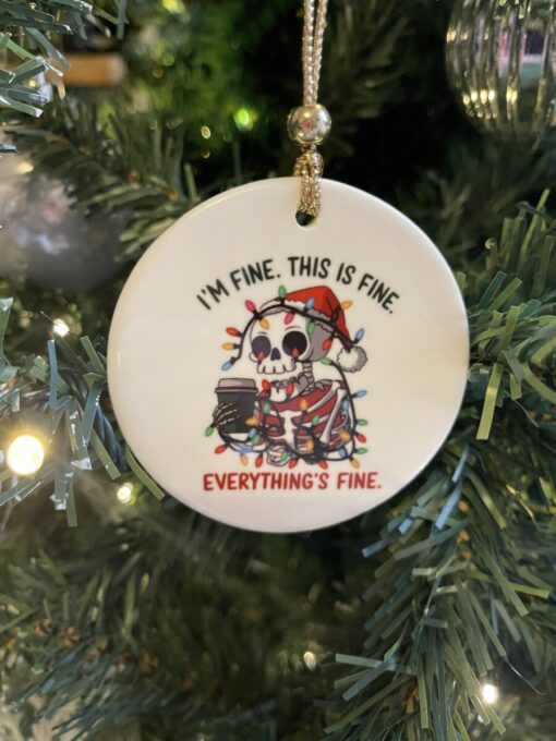 a white round ornament with a skeleton on it