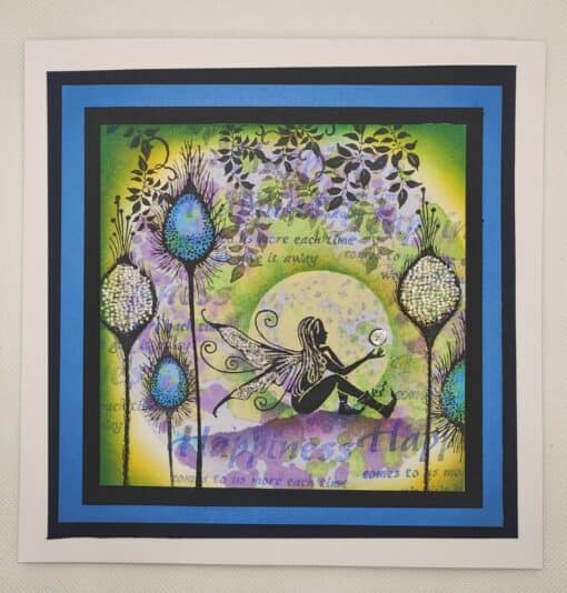 A whimsical fairy sits on the ground holding a glowing orb, surrounded by colorful flowers and foliage framed in blue and black.