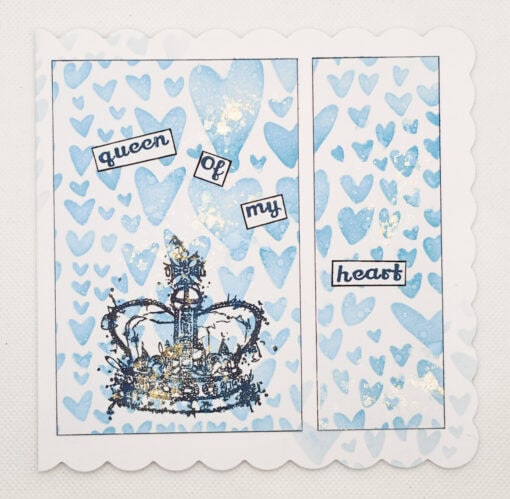 A handmade card with blue hearts, a crown, and text reading "queen of my heart" on a white scalloped border.