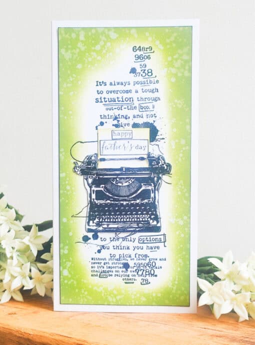 Greeting card with a vintage typewriter design and motivational text, saying "Happy Father's Day" placed on a green splatter background.