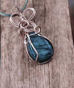 Elegant wire wrap pendant featuring a blue stone, perfect for unique wire wrapped pendant gifts and one-of-a-kind wire wrap pendants.