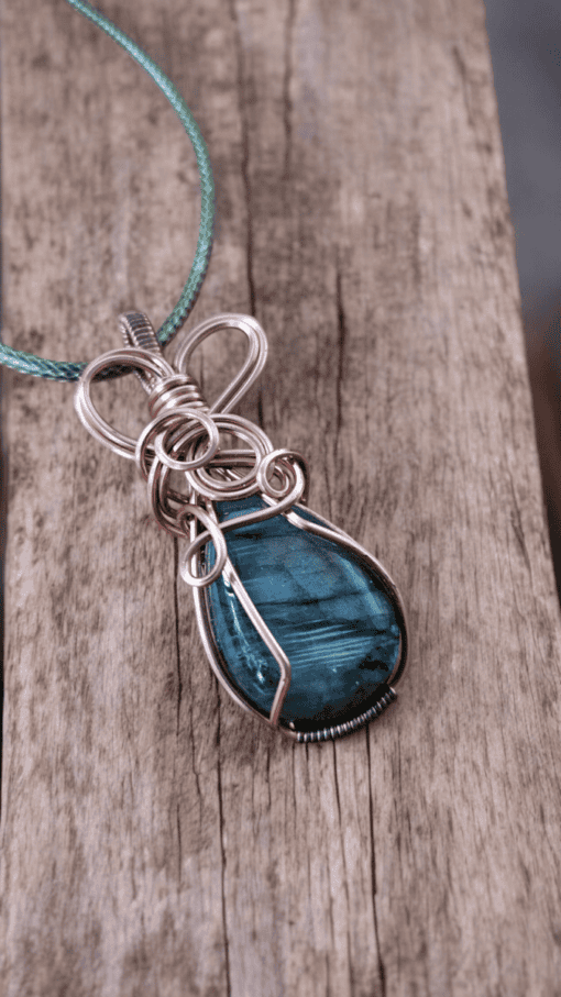 Elegant wire wrap pendant featuring a blue stone, perfect for unique wire wrapped pendant gifts and one-of-a-kind wire wrap pendants.