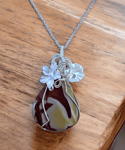 Boho-chic wire wrap necklace features nature-inspired design with floral elements and luxury wire wrapped around a polished stone.