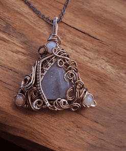 Wire-wrapped healing crystal necklace with intricate design, ideal for wedding statement pieces.