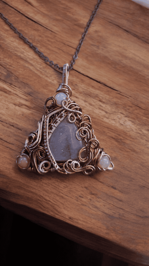 Wire-wrapped healing crystal necklace with intricate design, ideal for wedding statement pieces.