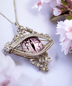 Ornate silver necklace featuring a decorative eye-like pendant with a purple iris, surrounded by pink flowers.