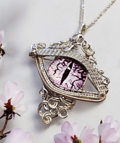 Intricately designed pendant resembling an eye with a purple iris, surrounded by delicate, blooming pink flowers.