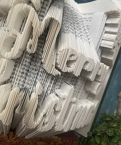 Folded pages of a book spelling 